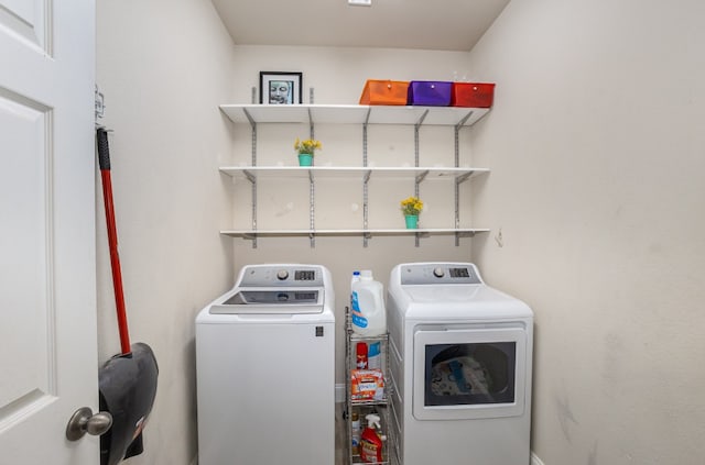 clothes washing area with washer and clothes dryer