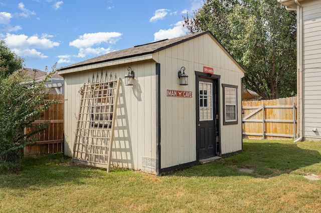 view of outbuilding featuring a lawn