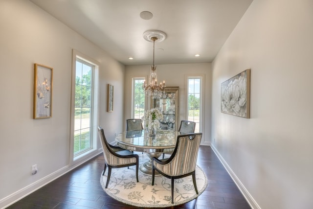 dining room featuring dark hardwood / wood-style floors and a chandelier