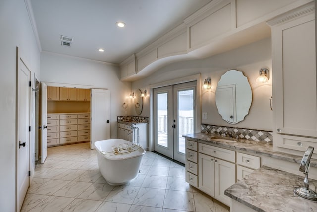 bathroom with a bath, vanity, french doors, tile patterned flooring, and tasteful backsplash