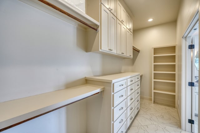 walk in closet with light tile patterned floors