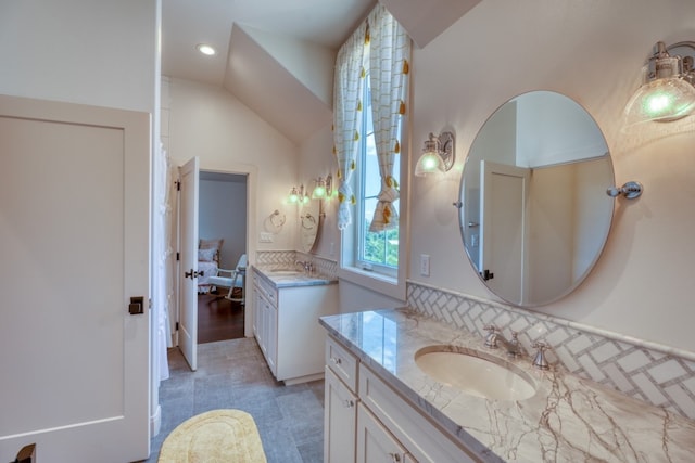 bathroom with vaulted ceiling, hardwood / wood-style flooring, and vanity