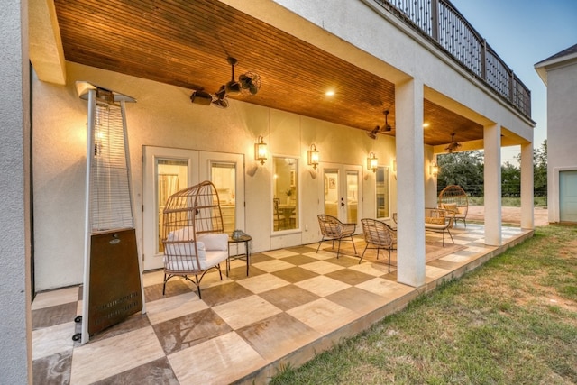 view of patio featuring ceiling fan, french doors, and a balcony