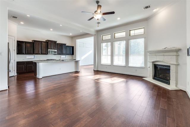 interior space featuring ceiling fan, dark hardwood / wood-style floors, and ornamental molding