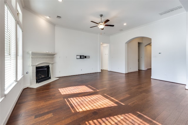 unfurnished living room with ceiling fan, dark wood-type flooring, and ornamental molding