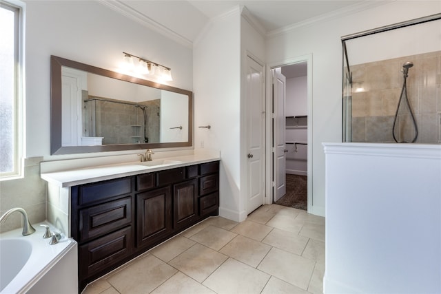 bathroom featuring crown molding, independent shower and bath, tile patterned floors, and vanity