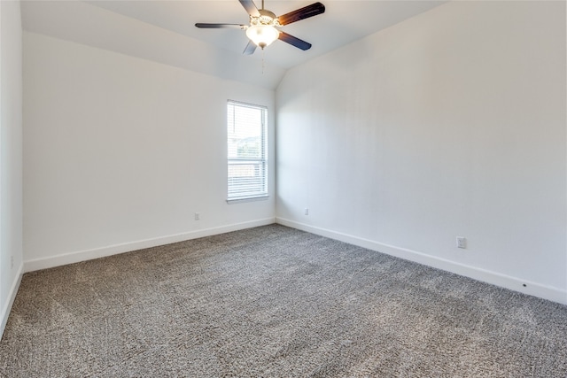 empty room with ceiling fan, lofted ceiling, and carpet flooring