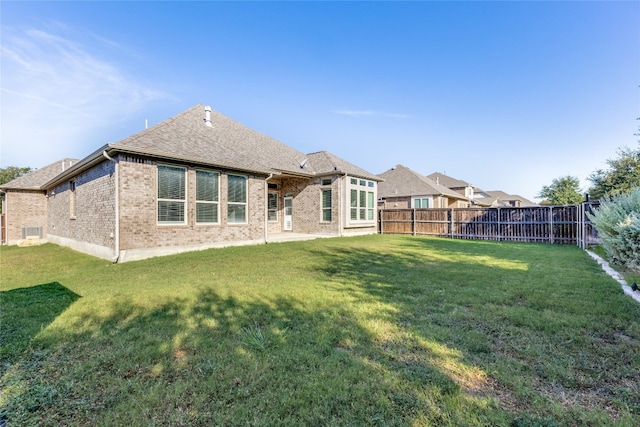 rear view of house with a yard