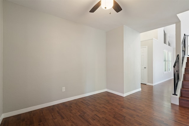 empty room with dark hardwood / wood-style floors and ceiling fan