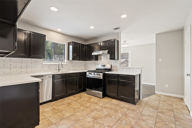 kitchen featuring sink, decorative backsplash, stainless steel appliances, and light tile patterned floors