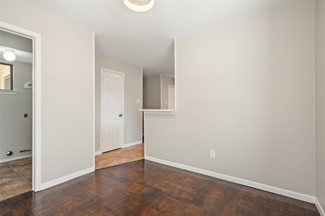 unfurnished room featuring dark tile patterned flooring