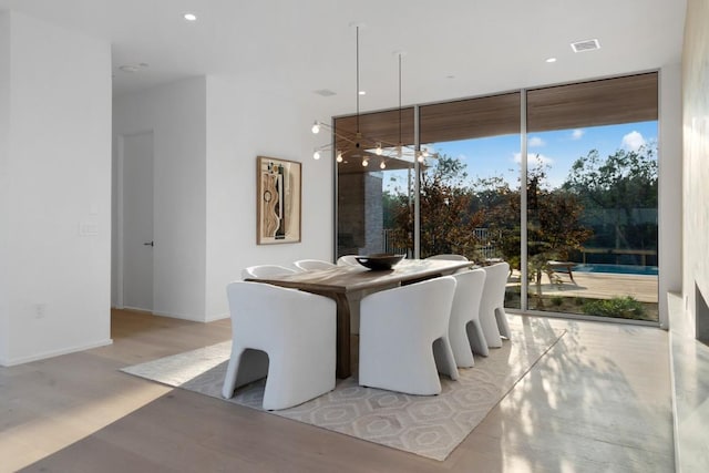 dining area with visible vents, baseboards, floor to ceiling windows, recessed lighting, and wood finished floors