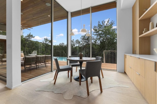 sunroom with a ceiling fan