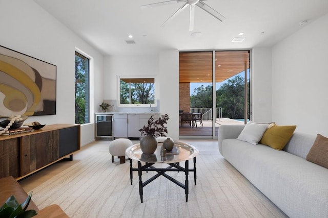 living area featuring a wall of windows, visible vents, recessed lighting, ceiling fan, and wine cooler