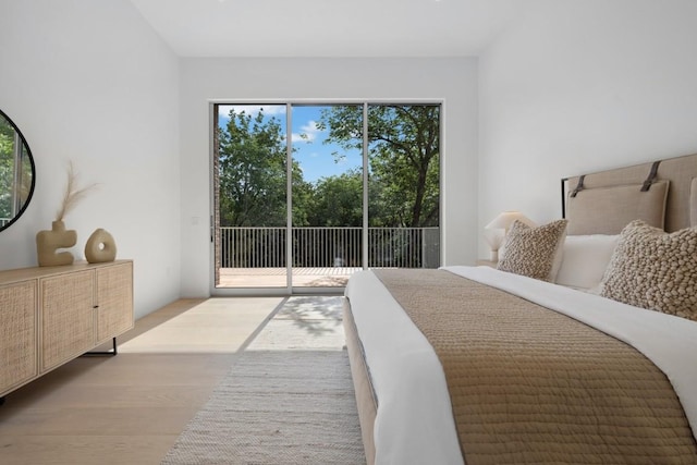 bedroom with wood finished floors and access to outside