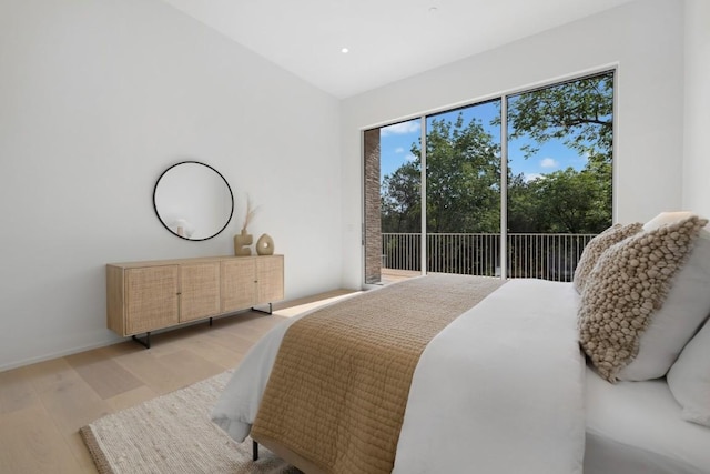 bedroom featuring access to exterior, recessed lighting, and light wood-style floors