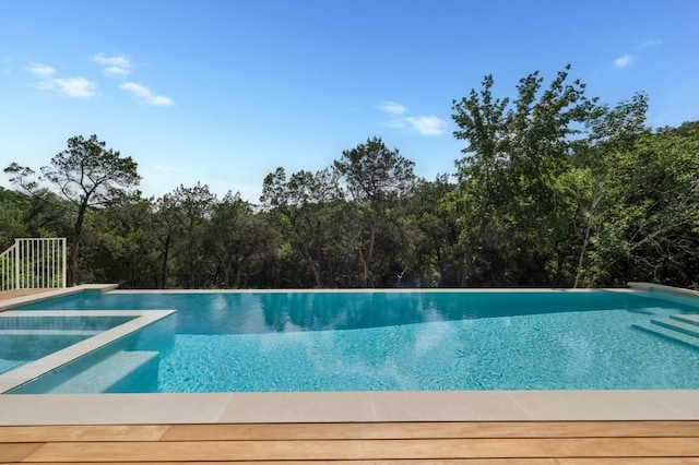 view of swimming pool featuring an infinity pool