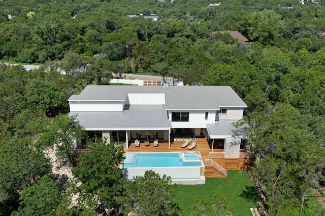 birds eye view of property with a forest view