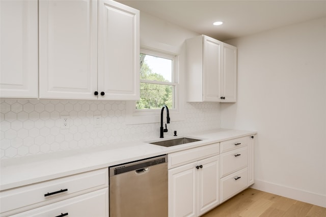 kitchen featuring sink, light hardwood / wood-style flooring, decorative backsplash, dishwasher, and white cabinetry