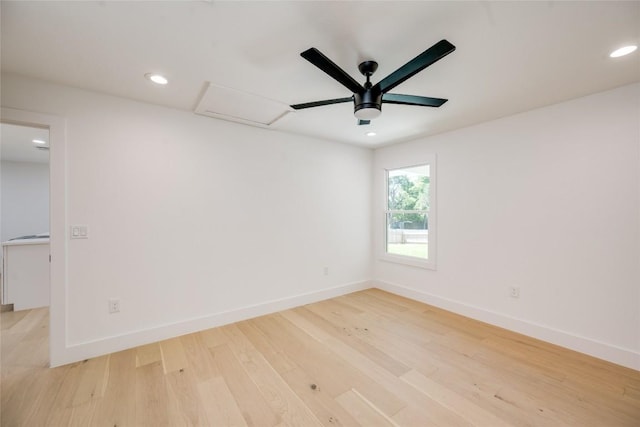 spare room with attic access, baseboards, light wood-style flooring, ceiling fan, and recessed lighting