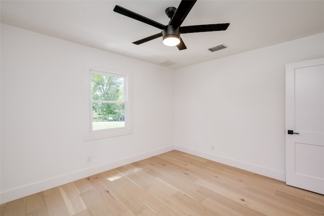 spare room featuring light hardwood / wood-style floors and ceiling fan