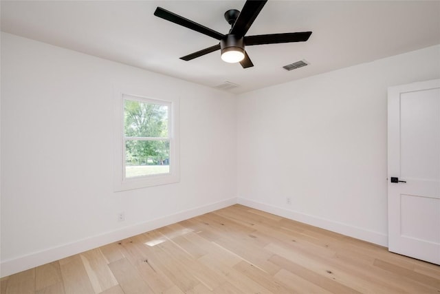 empty room with visible vents, ceiling fan, light wood-style flooring, and baseboards