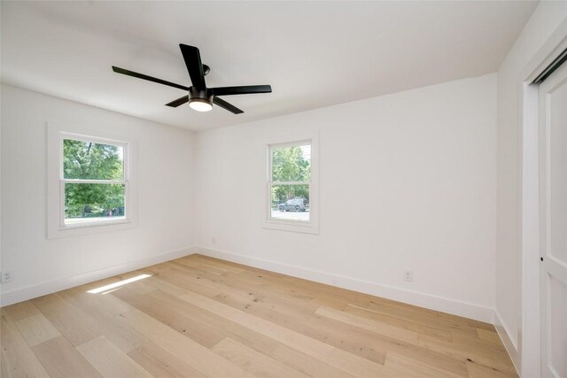 unfurnished room with ceiling fan, plenty of natural light, and light hardwood / wood-style floors