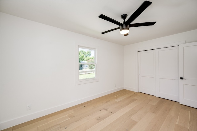 unfurnished bedroom featuring light hardwood / wood-style flooring, ceiling fan, and a closet