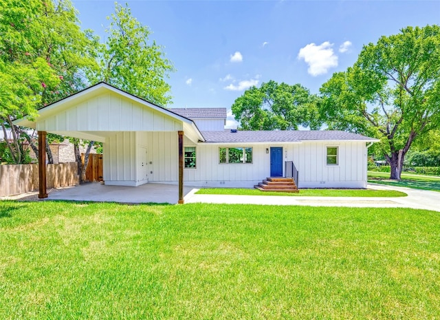 exterior space with a carport and a yard