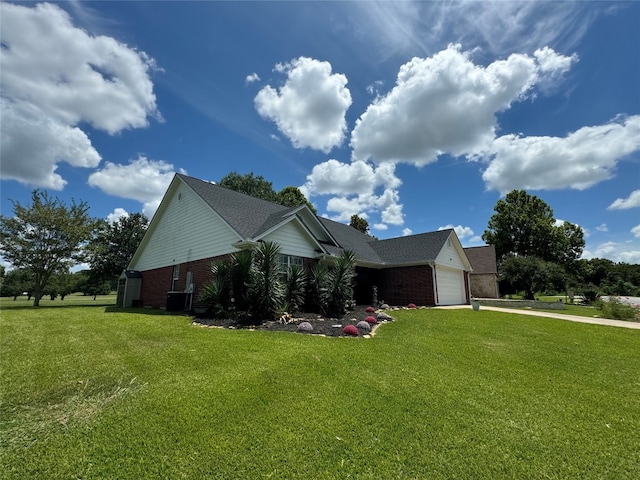 view of home's exterior with a lawn, a garage, and cooling unit