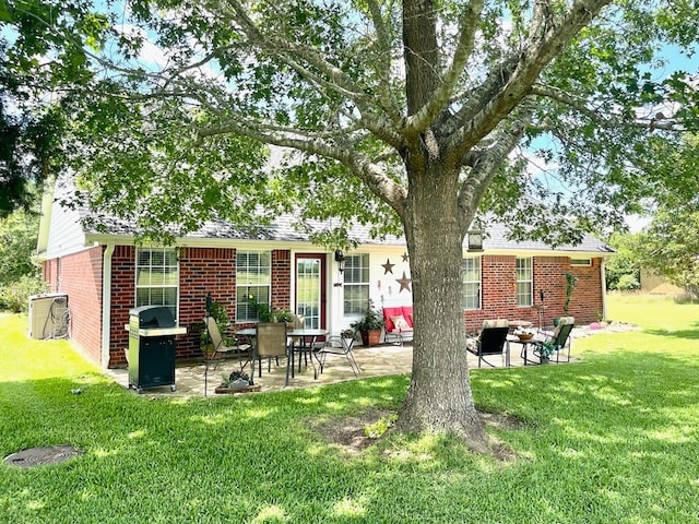 back of house featuring a patio and a yard