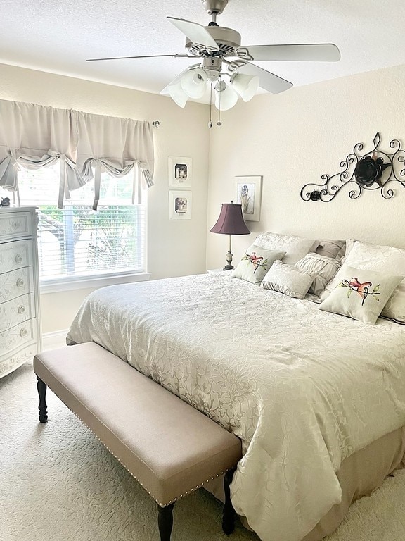 carpeted bedroom with ceiling fan