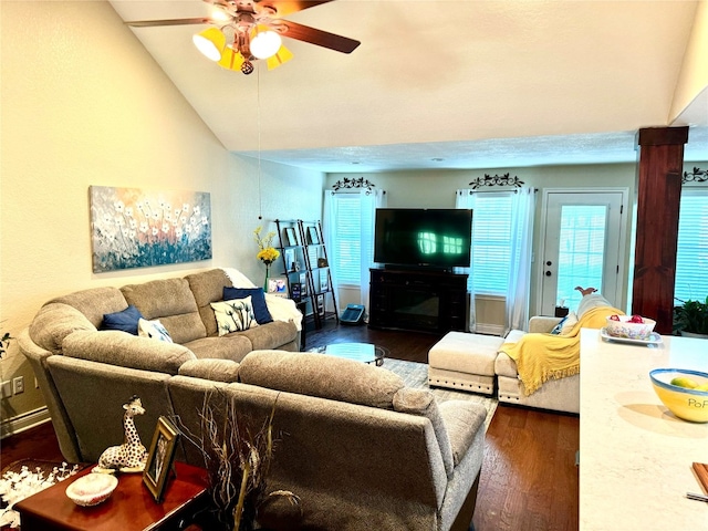 living room featuring ceiling fan, vaulted ceiling, and dark wood-type flooring