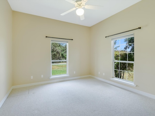 spare room featuring carpet and ceiling fan