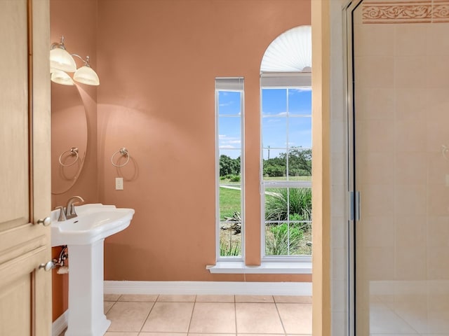 bathroom featuring sink, walk in shower, and tile patterned floors