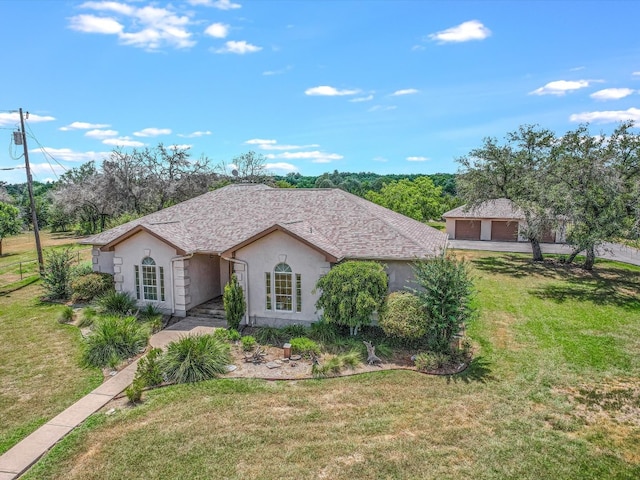 ranch-style house with a garage and a front lawn