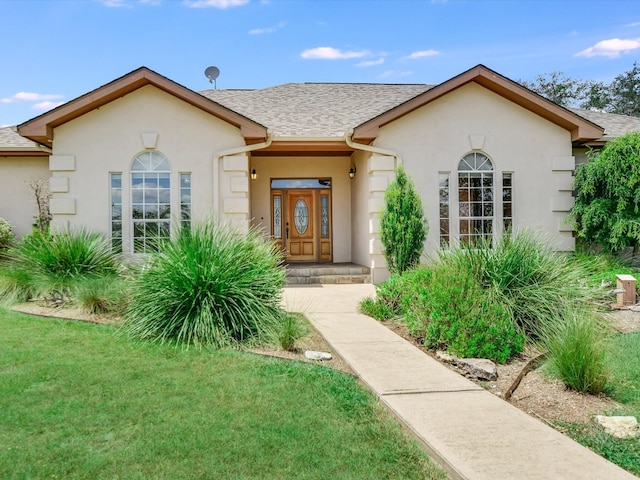 view of front facade featuring a front lawn and french doors