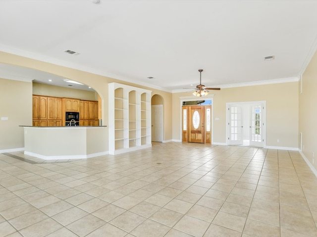 unfurnished living room featuring ceiling fan, ornamental molding, french doors, sink, and light tile patterned flooring