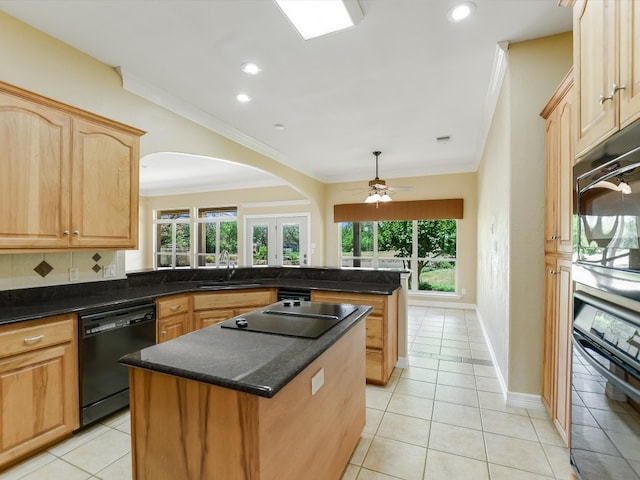 kitchen with sink, black appliances, light tile patterned floors, a kitchen island, and ceiling fan