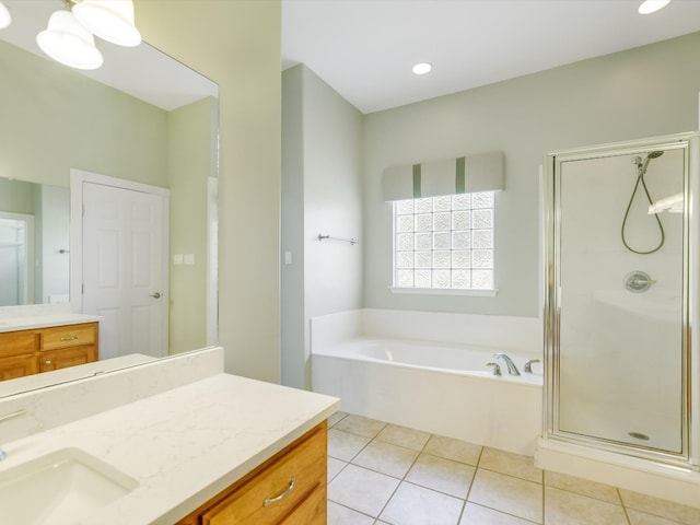 bathroom featuring tile patterned flooring, plus walk in shower, and vanity