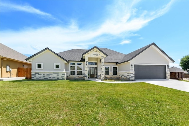 view of front of house featuring a garage, fence, driveway, stone siding, and a front lawn