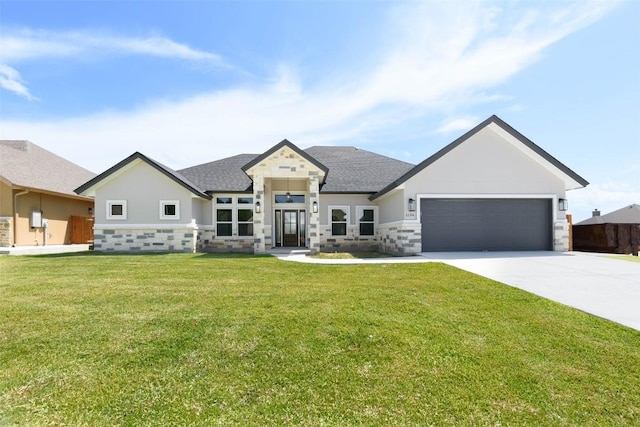 view of front of house featuring driveway, stone siding, an attached garage, and a front lawn