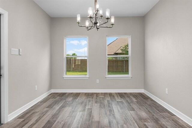 interior space featuring hardwood / wood-style flooring and a chandelier