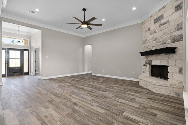 unfurnished living room featuring a stone fireplace, visible vents, baseboards, dark wood-style floors, and crown molding