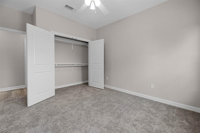 unfurnished bedroom featuring a closet, ceiling fan, and light colored carpet