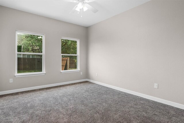 carpeted empty room featuring ceiling fan