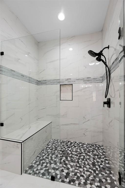 full bath featuring tiled shower