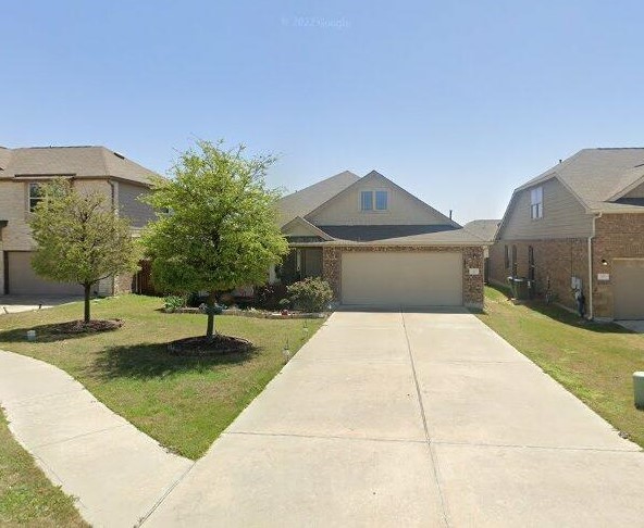 view of front facade featuring a garage and a front lawn