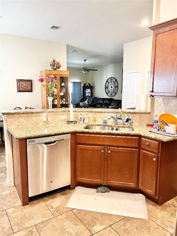 kitchen with backsplash, light tile patterned floors, dishwasher, sink, and ceiling fan