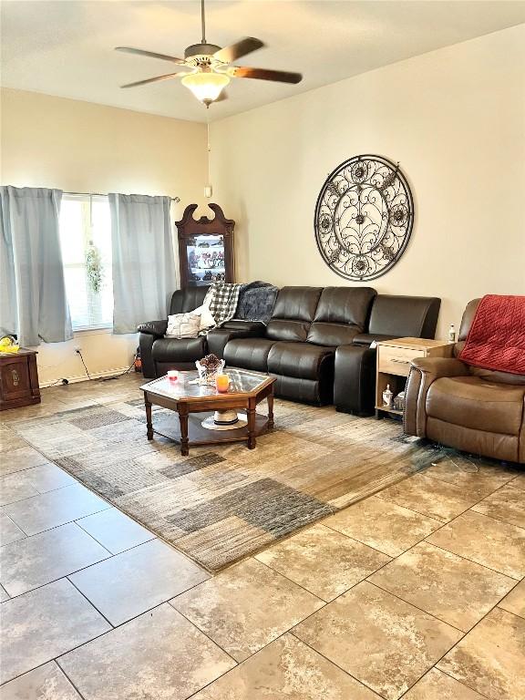 living room with ceiling fan and light tile patterned floors